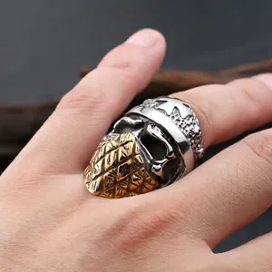 Punk style bicolor skull ring for men with pineapple pattern mask detail on finger