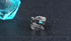 Macro shot of turquoise stone on a silver feather ring with detailed textures