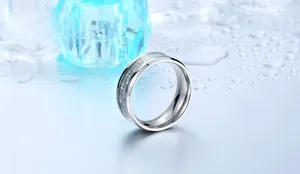 Macro detail of titanium steel ring featuring inlaid grey and white carbon fiber texture