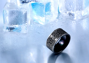 Macro detail of vintage black titanium steel ring featuring mythical beast relief carving