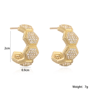Macro detail of C-shaped geometric earrings with 18K gold plating and white zircons