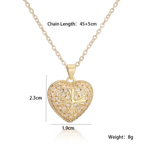 Detailed view showing 18K gold plated heart pendant with zircon inlay and cross relief
