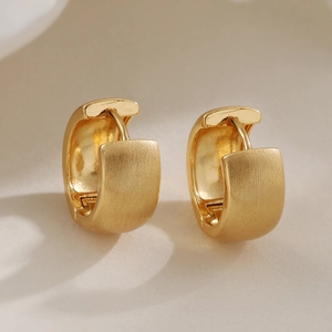 Minimalist gold-plated hoop earrings with brushed finish and polished inner surface