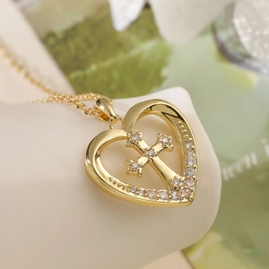 Elegant 18K gold plated heart necklace with zircon cross pendant on a white jewelry stand