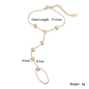 Detailed view of gold stainless steel heart slave bracelet with lobster clasp and chain