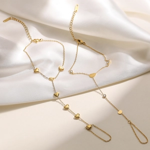Elegant 18K gold-plated stainless steel slave bracelet with heart charms and cubic zirconia