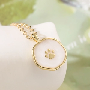 Chic 18K gold plated necklace with a cute cat paw print pendant in white enamel