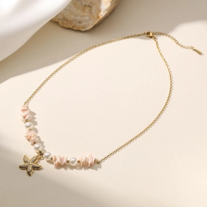 Ocean style gold chain necklace featuring a starfish pendant and elegant white pearls