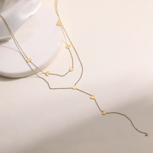 Collier double couche en acier inoxydable doré avec breloques cœur et design de pompon