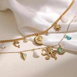 Gold stainless steel ocean themed necklaces with sea stars, dolphins and conch shells charms