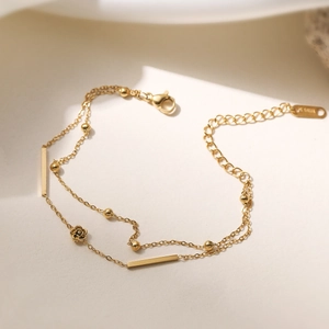Elegant gold double-layered stainless steel necklace with rose pendant and beaded details