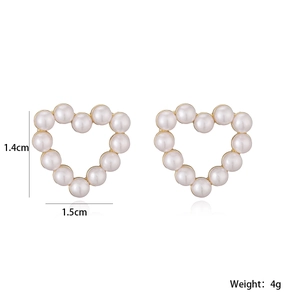 Detail view showing heart-shaped pearl earrings with gold base dimensions 1.4cm by 1.5cm