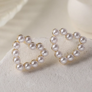 Elegant 18K gold plated heart stud earrings with white pearls for a luxury look