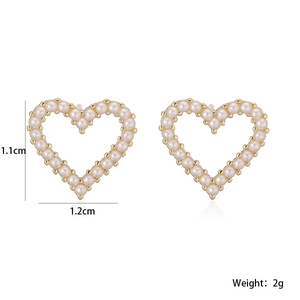 Detailed view of gold heart stud earrings with white pearls and 1.1cm by 1.2cm size specs