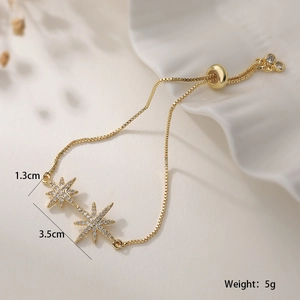 Detail of 18K gold plated copper bracelet with sparkling zircon stars and slider clasp