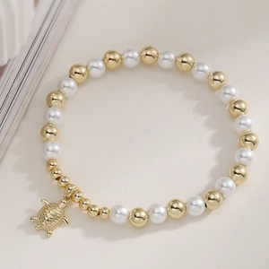 Chic beach style pearl and gold bead bracelet featuring a detailed turtle pendant