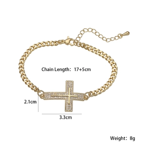 Détail d'un bracelet gourmette plaqué or 18 carats avec un pendentif croix en zircone