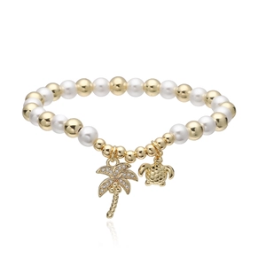 Elegant ocean pearl bracelet featuring golden turtle and palm tree charms with crystals
