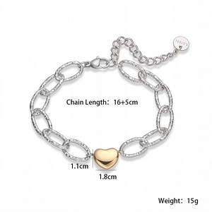 Detailed view of 18K gold-plated heart charm on a chunky diamond-cut stainless steel chain