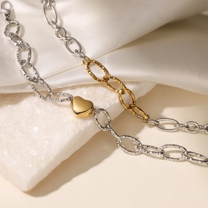 Two-tone 18K gold plated stainless steel heart bracelet on white silk and stone