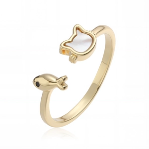 Close-up of gold-plated cat and fish ring with white mother of pearl inlay details