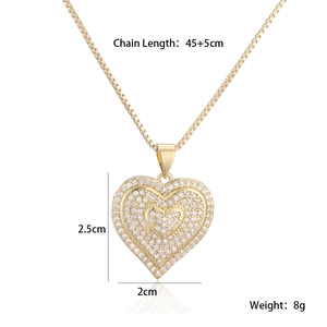 Macro shot of gold heart pendant with detailed white zircon pavé and fine cable chain