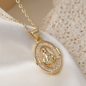 18K gold plated Mary pendant necklace with sparkling cubic zirconia on silk background