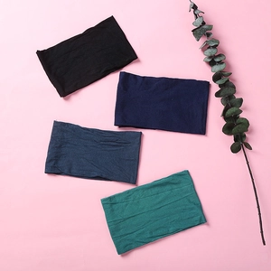 Close-up of four soft nylon baby headbands in black, navy, denim blue and dark green