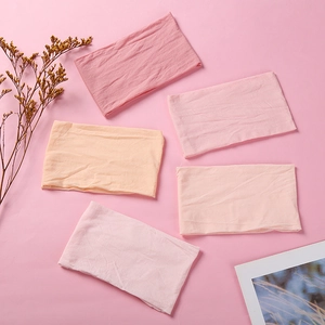 Set of five soft nylon elastic headbands for infants in varied shades of pink and coral