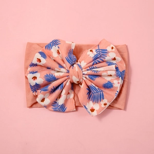 Pink nylon baby headband with large floral bow and palm leaf print on soft wide band