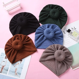 Adorable waffle knit baby turban hats with stylish top knots in five versatile soft colors