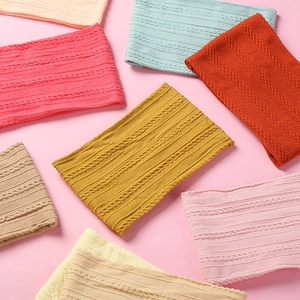 Close-up of soft jacquard nylon baby headbands showing knit textures and varied colors