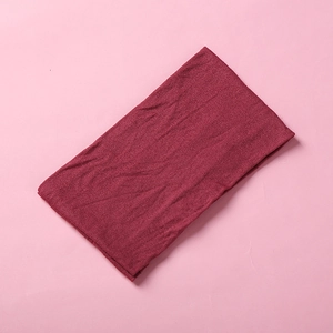 Detail shot of the soft knitted texture and burgundy nylon fabric of this baby headband