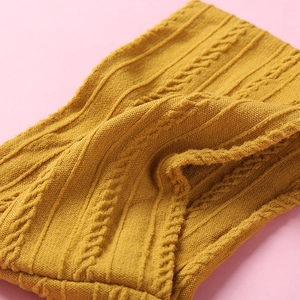 Ultra-soft jacquard nylon baby headband in mustard yellow with classic cable knit pattern
