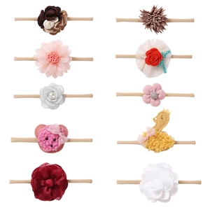 Set of 10 soft nylon baby headbands with assorted fabric flowers and plush ornaments