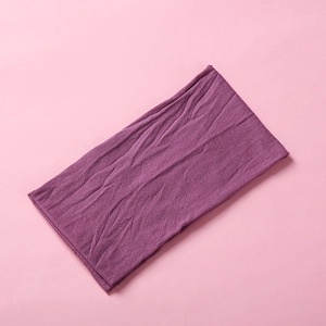 Close-up of soft burgundy nylon headband with detailed high-elastic knitted fabric texture