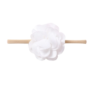 Detailed macro view of soft white chiffon flower headband with elastic nylon band for babies