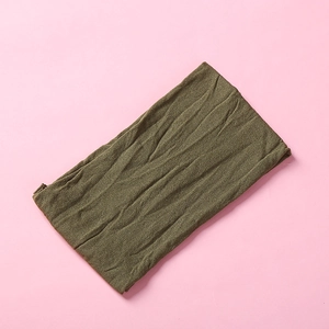 Detail of dark olive green nylon headband showing the elastic pleated texture and fabric