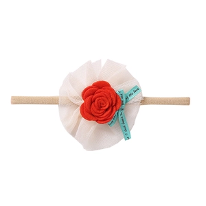 Close-up of baby nylon headband featuring red felt rose and white polka dot mesh lace