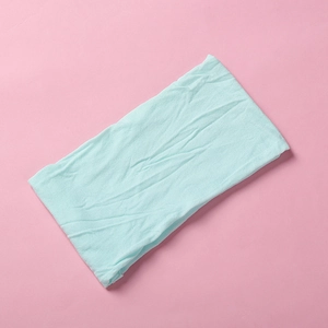 Detail shot of the mint green soft nylon headband showing textured knitted fabric