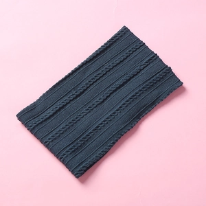 Macro shot of navy blue jacquard knit texture on soft nylon baby headband accessory