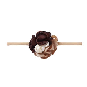 Detail of baby headband with multi-color satin flower petals and soft nylon band