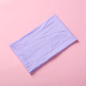 Detail view of purple soft nylon baby headband with stretchable ribbed knitted texture