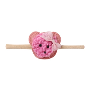 Detail showing soft pink sherpa bear with mesh bow on stretchy nylon baby headband