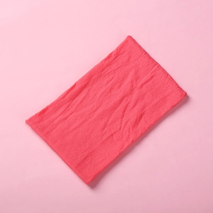 Detailed macro view of soft coral pink knitted nylon fabric with high elasticity and fine texture