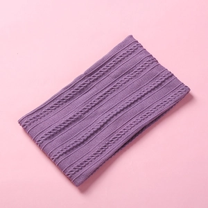 Macro shot of lilac purple cable-knit pattern and soft ribbed texture of the headband