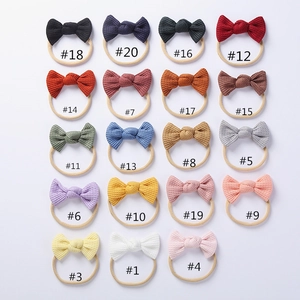 Detailed flat lay of 19 colorful waffle knit baby headbands with soft nylon elastic bands