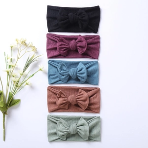 Set of five ribbed knit baby headbands with large bows in various soft colors
