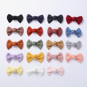 Set of 19 solid color waffle knit bow hair clips for girls in various vibrant macaron shades