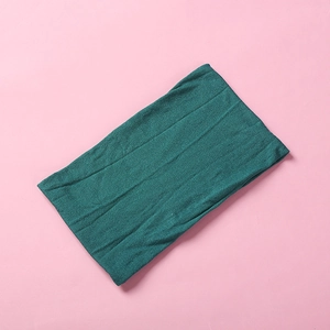 Detail of soft dark green nylon fabric texture on a wide elastic baby headband